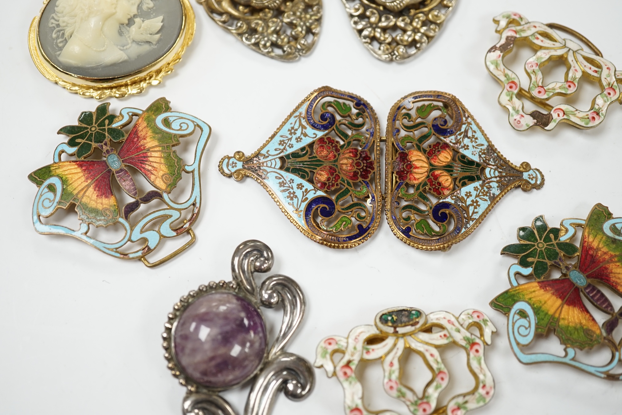 A Mexican Los Castillo sterling and cabochon amethyst set foliate brooch, 60mm, a small collection of base metal and cloisonné enamel belt buckles and a cameo brooch. Condition - poor to fair